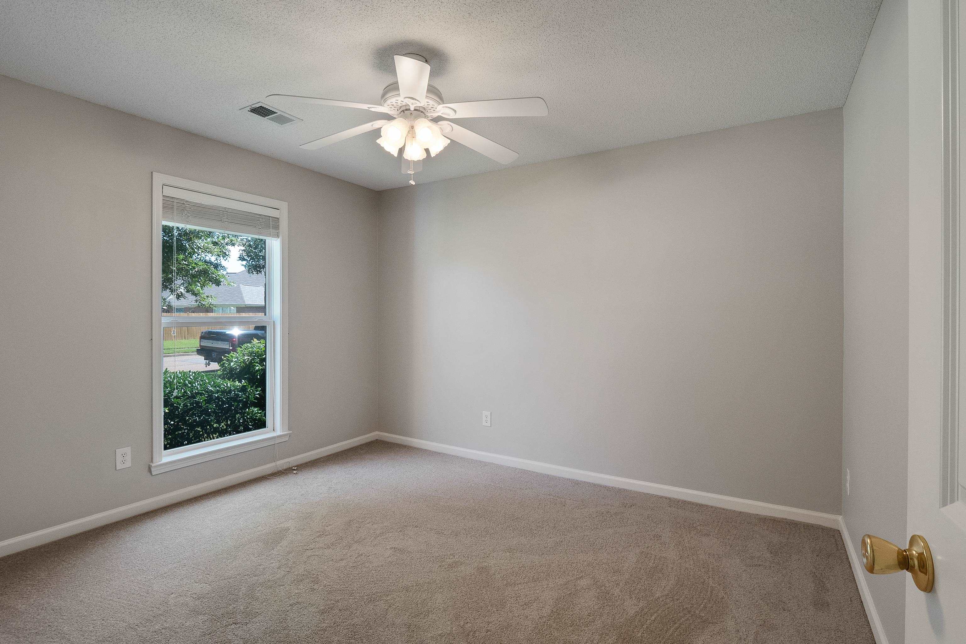 1171 Macon Hall Road Cordova, TN 38018 - Photo 22 of 35 an empty room with windows and chandelier fan