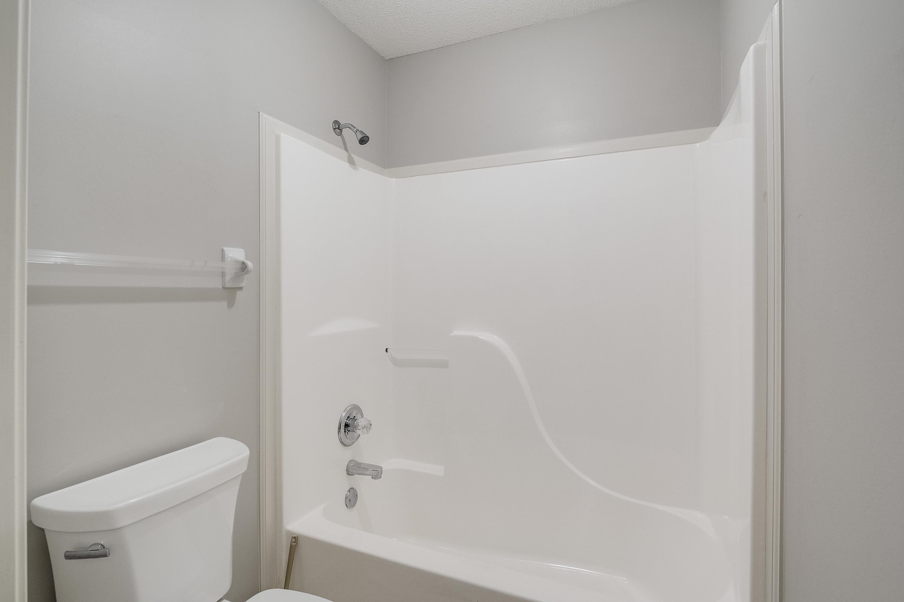 1171 Macon Hall Road Cordova, TN 38018 - Photo 25 of 35 a bathroom with a bathtub and a toilet