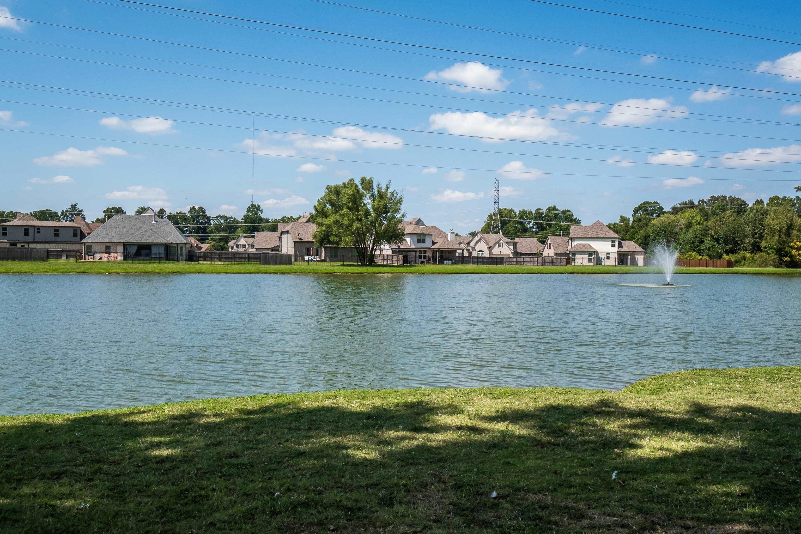 1171 Macon Hall Road Cordova, TN 38018 - Photo 34 of 35 a view of a city with lawn chairs and a lake view