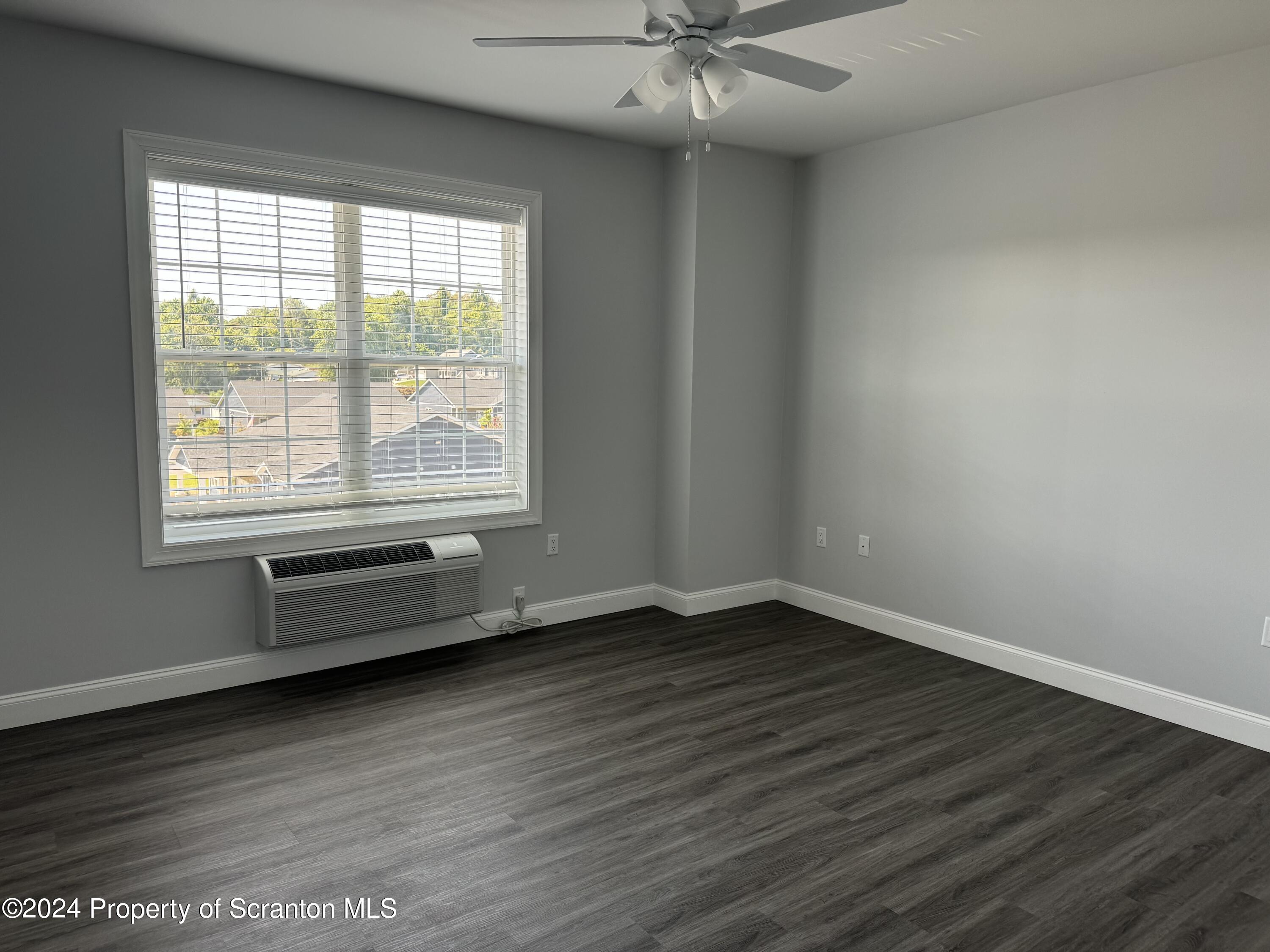 104 Circle Drive Taylor, PA 18517 - Photo 15 of 31 an empty room with wooden floor and windows