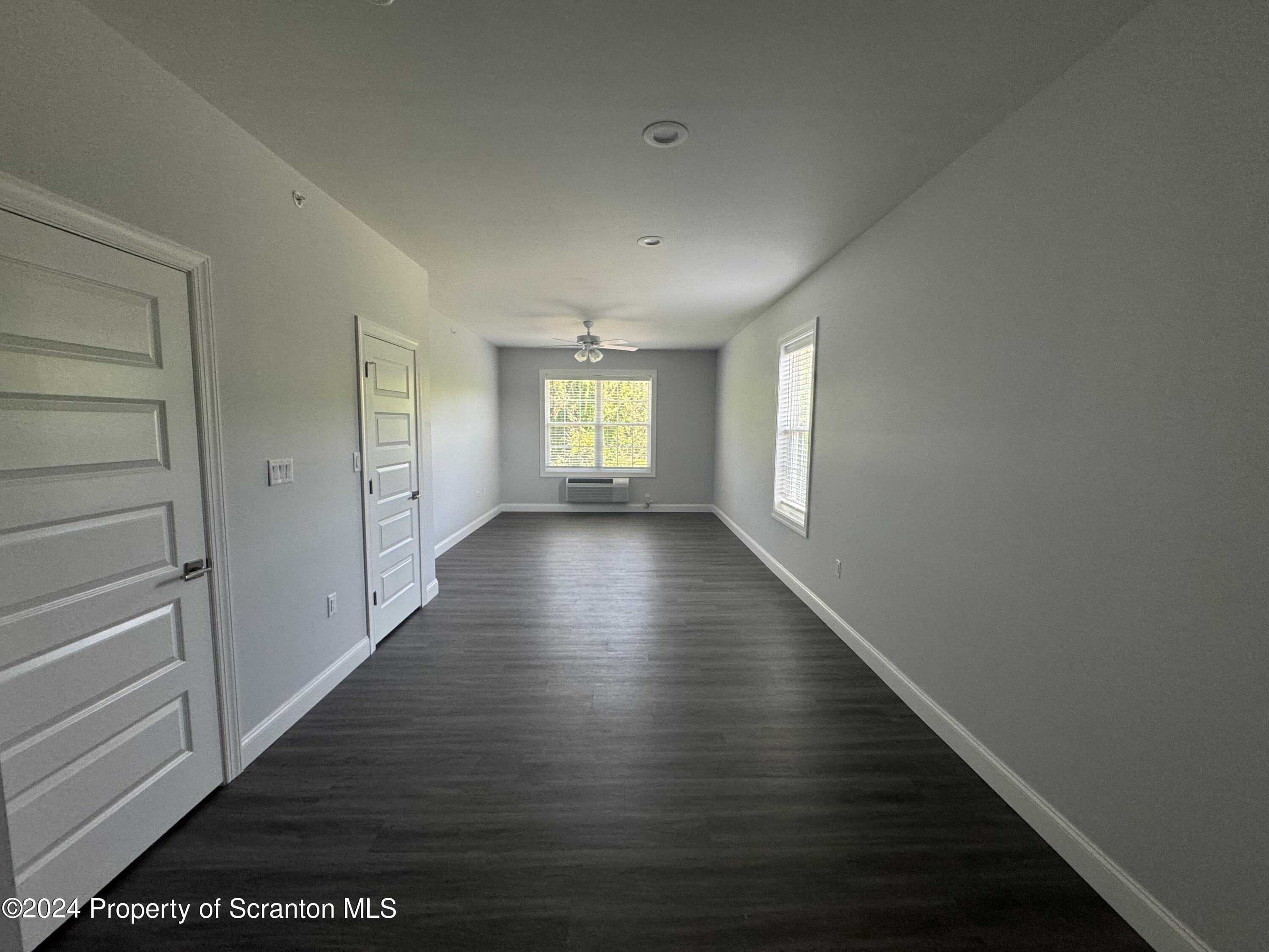 104 Circle Drive Taylor, PA 18517 - Photo 22 of 31 a view of an empty room with wooden floor and a window