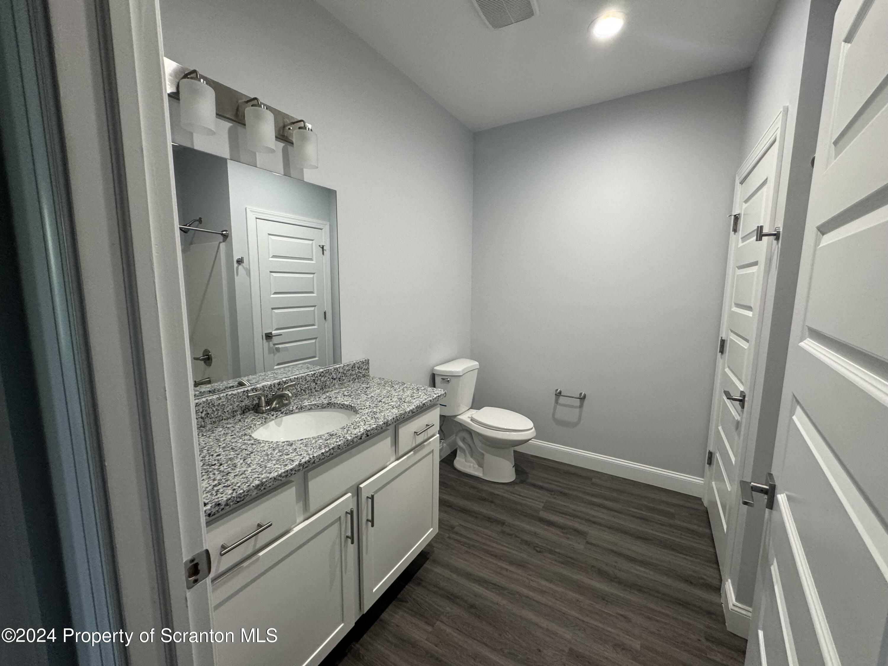 104 Circle Drive Taylor, PA 18517 - Photo 23 of 31 a bathroom with a granite countertop toilet and a sink