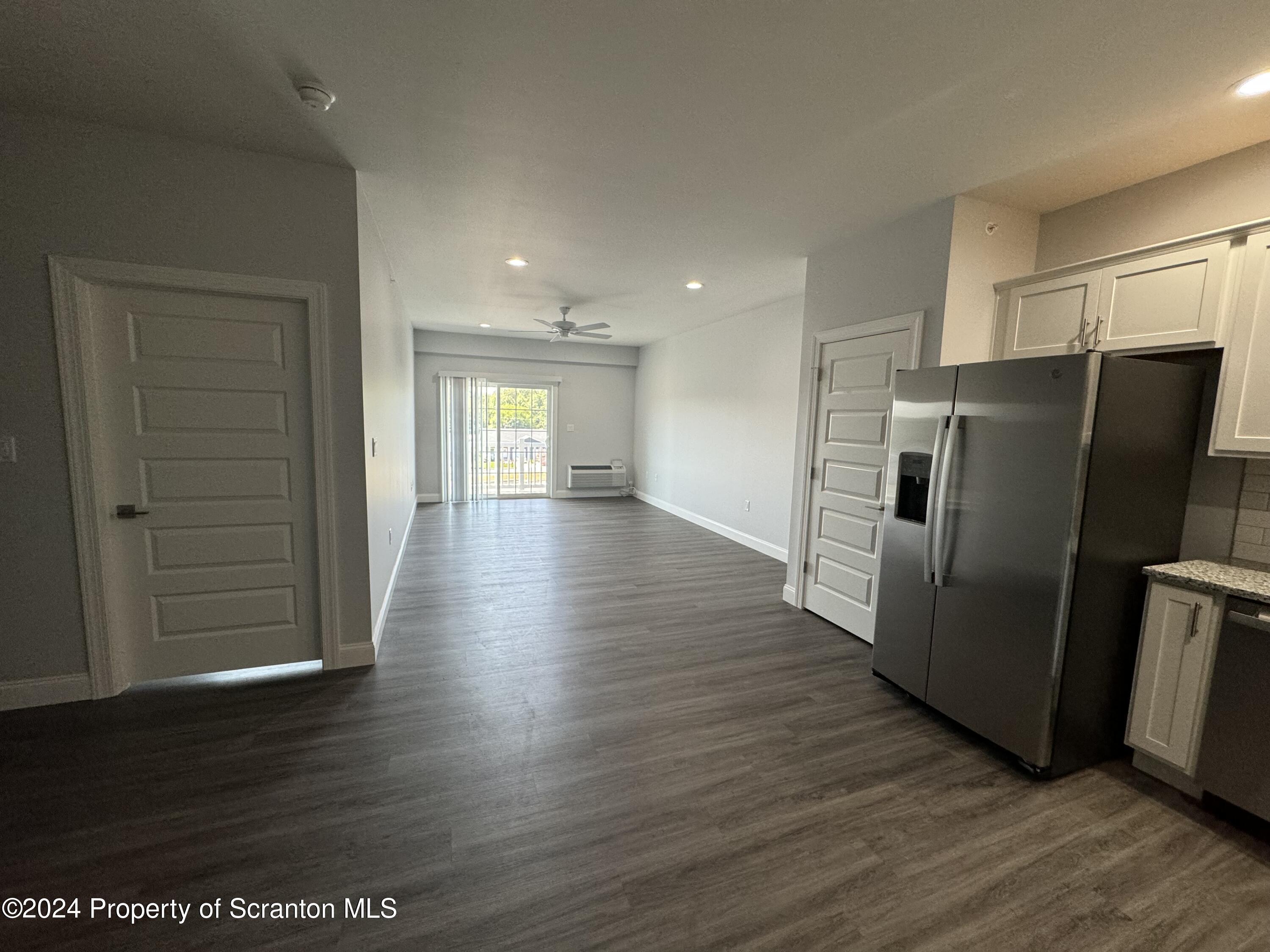 104 Circle Drive Taylor, PA 18517 - Photo 24 of 31 a view of a refrigerator in kitchen and wooden floor