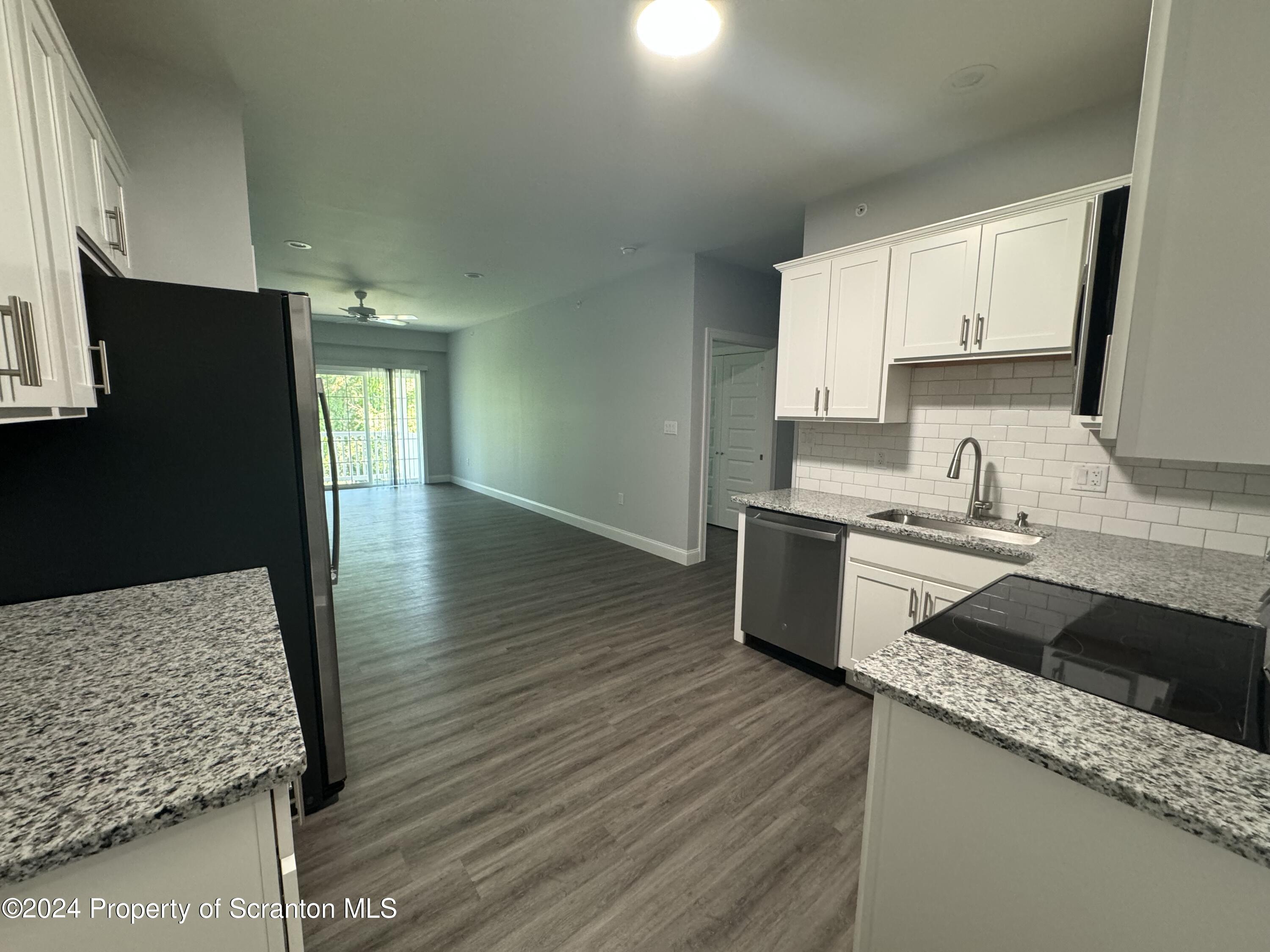 104 Circle Drive Taylor, PA 18517 - Photo 5 of 31 a kitchen with stainless steel appliances granite countertop a sink stove and refrigerator