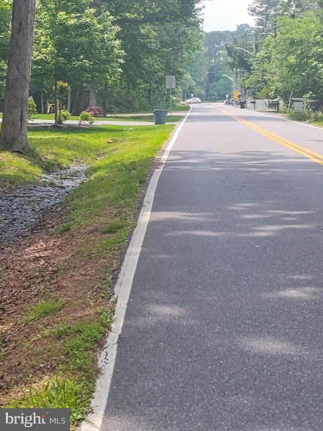700 Maple Avenue North Beach, MD 20714 - Photo 9 of 12 a view of a house with a big yard and large trees