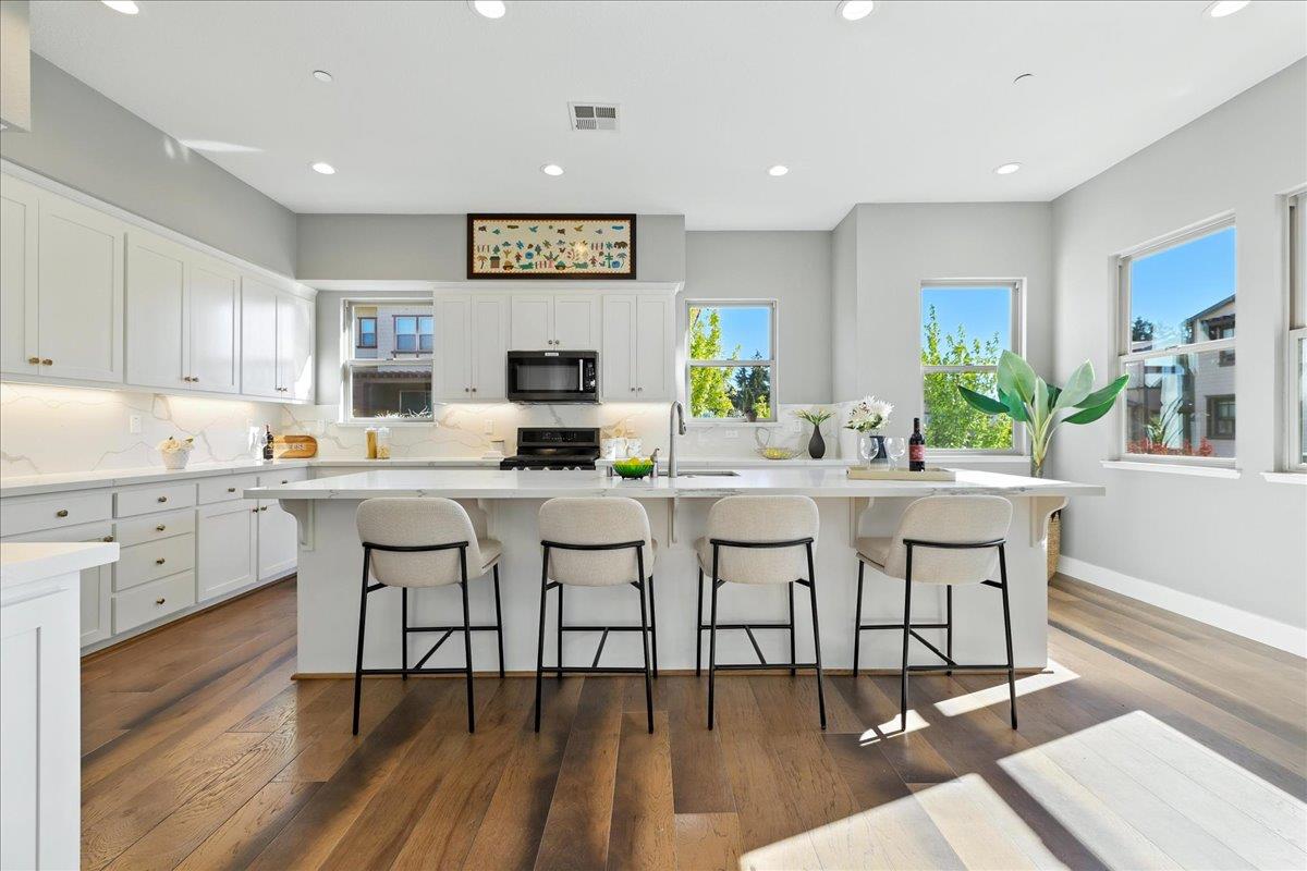 324 Cherokee Loop Mountain View, CA 94043 - Photo 14 of 62 a kitchen with white cabinets and chairs