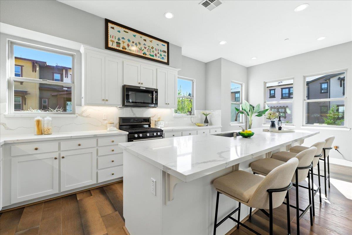 324 Cherokee Loop Mountain View, CA 94043 - Photo 16 of 62 a kitchen with a sink cabinets and wooden floor