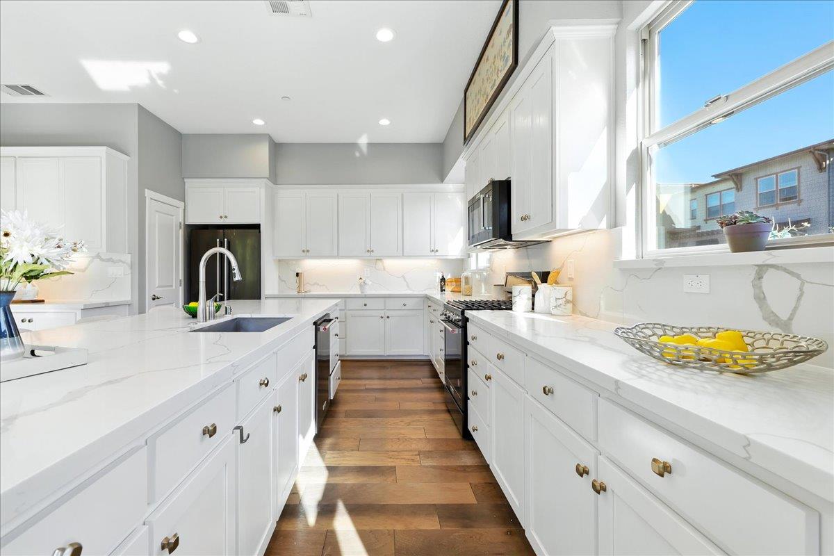 324 Cherokee Loop Mountain View, CA 94043 - Photo 20 of 62 a kitchen with white cabinets sink and stove