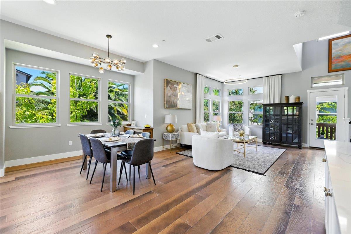 324 Cherokee Loop Mountain View, CA 94043 - Photo 7 of 62 a dining room with wooden floor a chandelier a wooden table and chairs