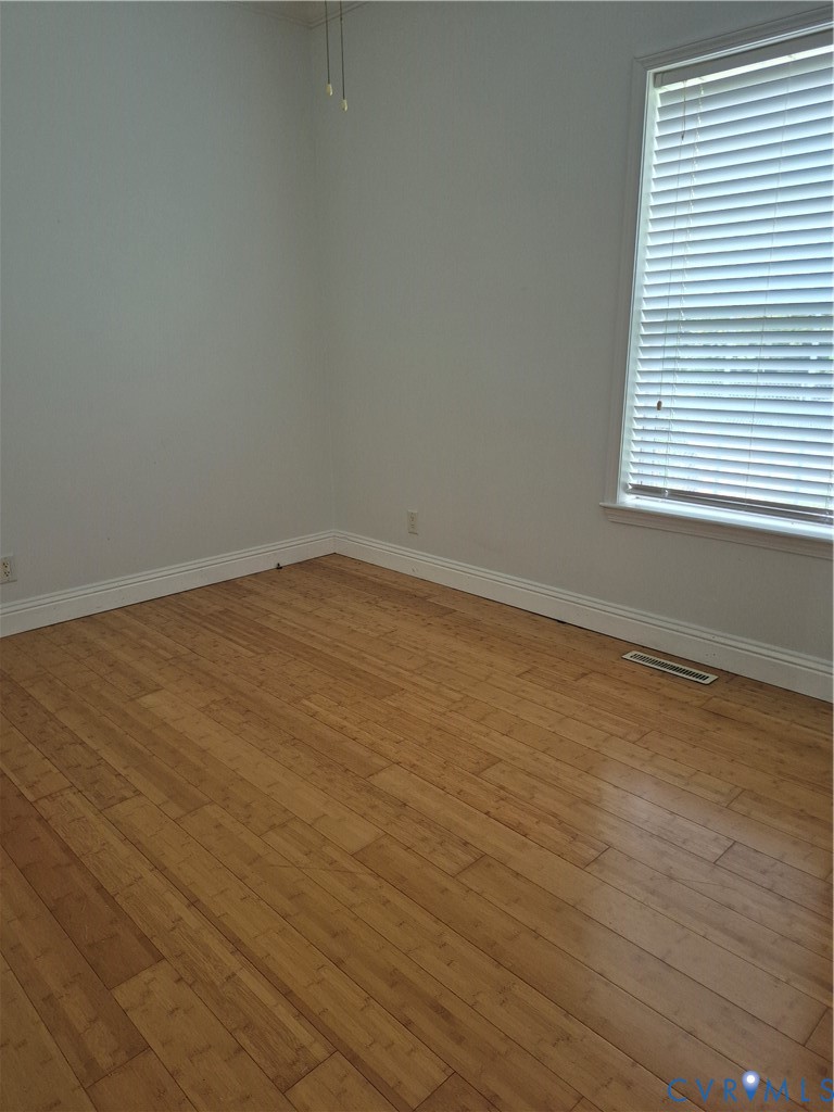 10541 Continental Road Quinton, VA 23141 - Photo 13 of 15 Wood-finish flooring with white baseboards, a wind