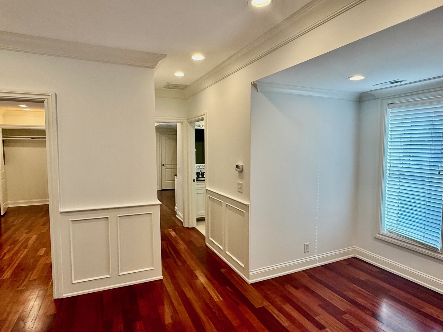 1000 Ridge Road, Unit 2 Wilmette, IL 60091 - Photo 8 of 11 a view of an empty room with wooden floor and a window