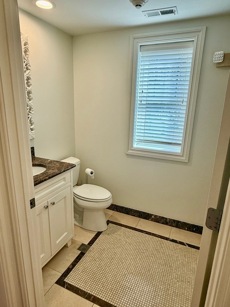 1000 Ridge Road, Unit 2 Wilmette, IL 60091 - Photo 9 of 11 a bathroom with a toilet a sink and a window