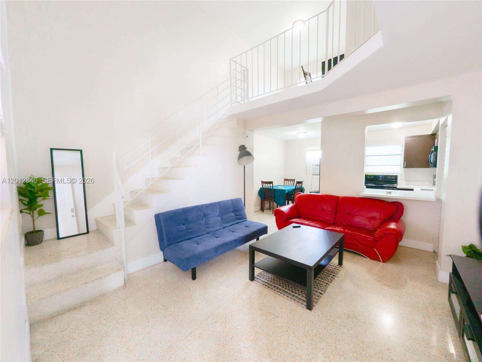 1220 Southwest 5th Street, Unit 16 Miami, FL 33135 - Photo 3 of 8 a living room with furniture and a potted plant