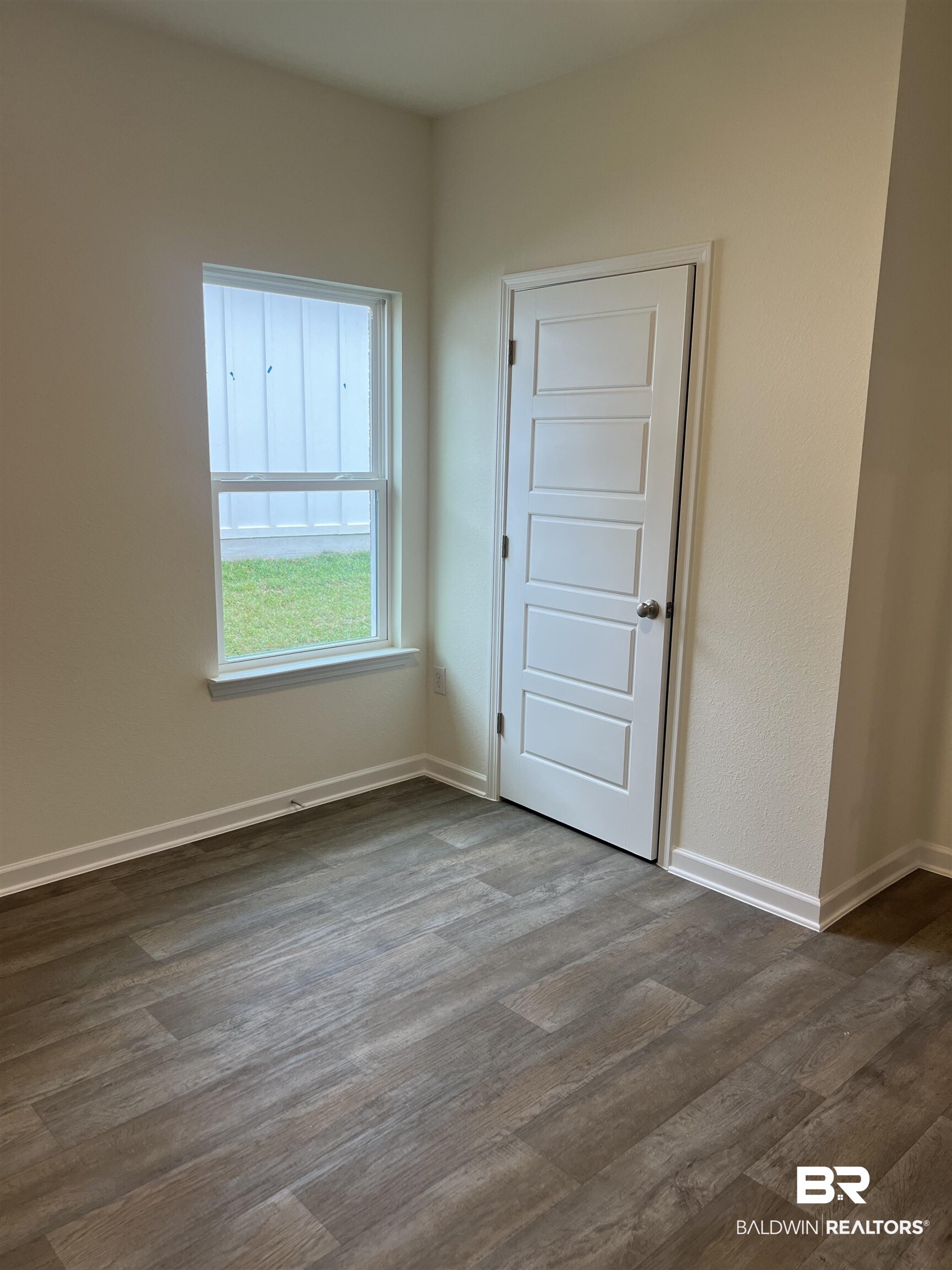 12829 Patriot Way Daphne, AL 36527 - Photo 12 of 38 Unfurnished room featuring dark hardwood / wood-style flooring