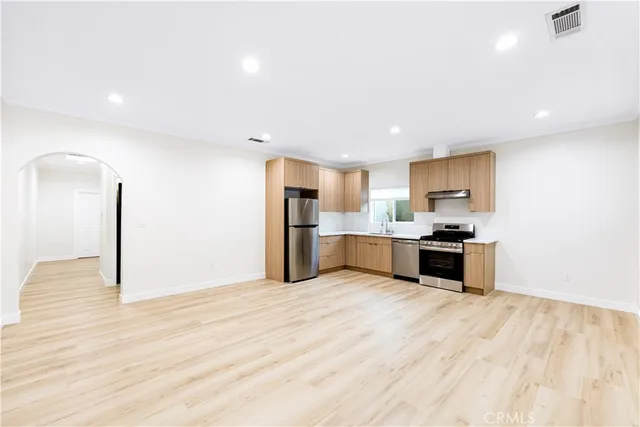a kitchen with stainless steel appliances a refrigerator and a sink