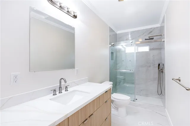 a bathroom with a sink toilet a mirror and shower