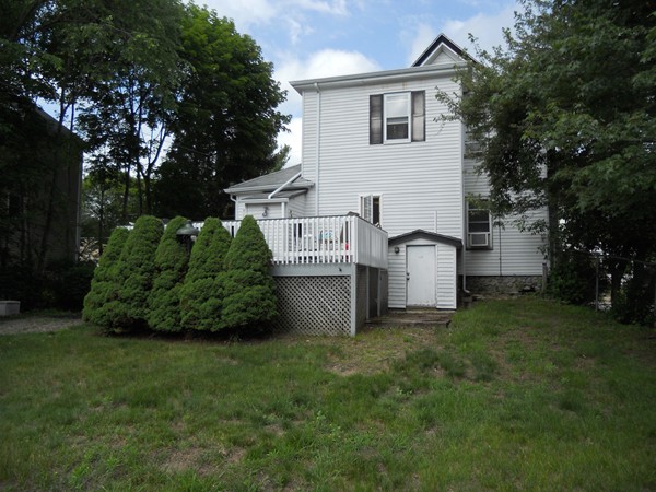 52 Malvern Road Brockton, MA 02301 - Photo 7 of 8 a view of a house with a yard and a garage