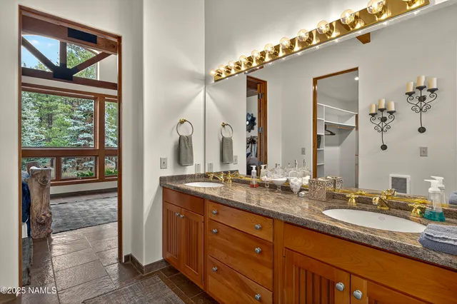 a bathroom with a granite countertop sink mirror and double