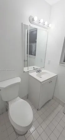 a bathroom with a sink toilet and mirror