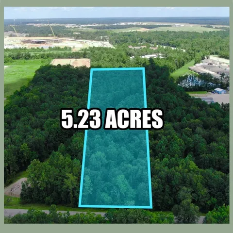 a view of a field with an ocean view