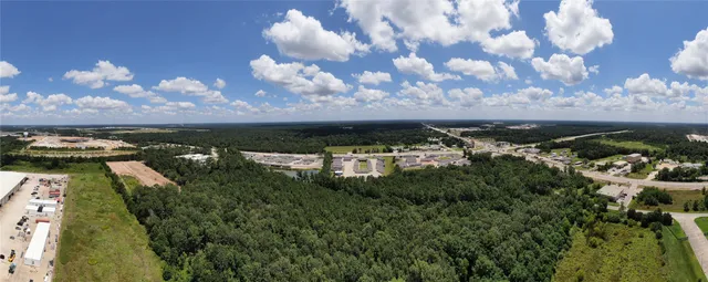 a view of flowing water with large trees