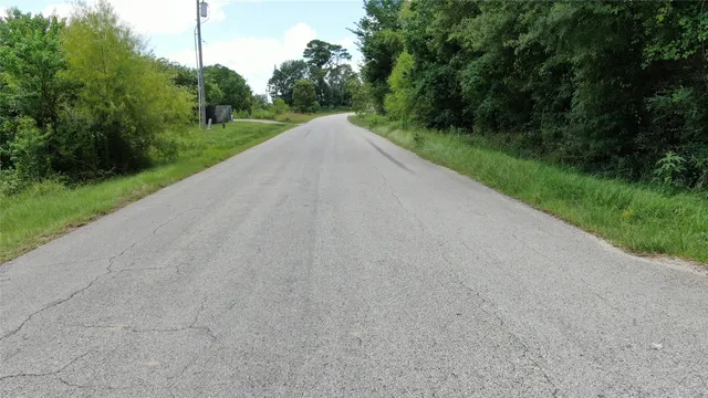a view of a park with a street