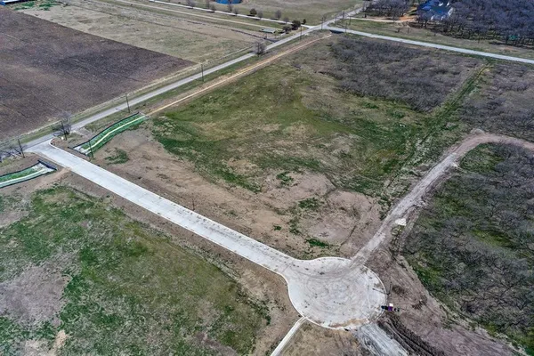 a view of a yard with large trees