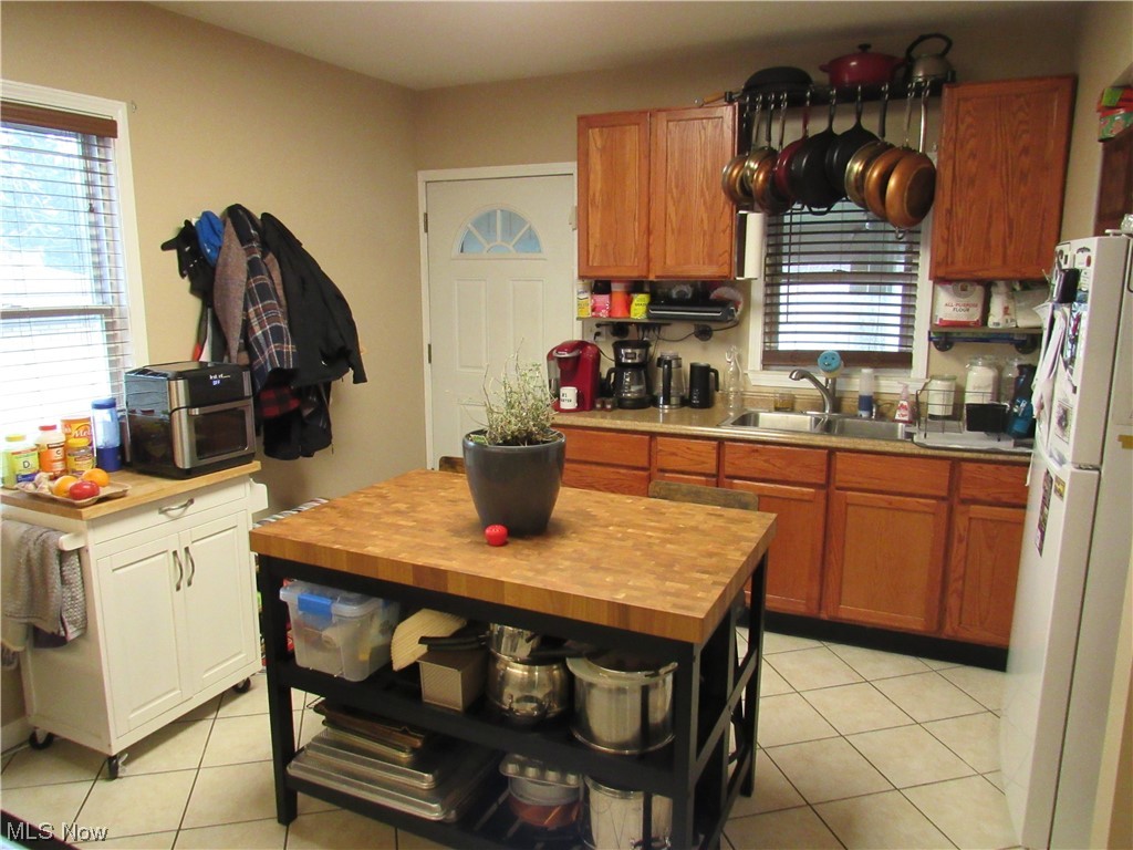 6311 Ridge Road Parma, OH 44129 - Photo 8 of 26 Kitchen with butcher block countertops, white refrigerator, sink, and plenty of natural light