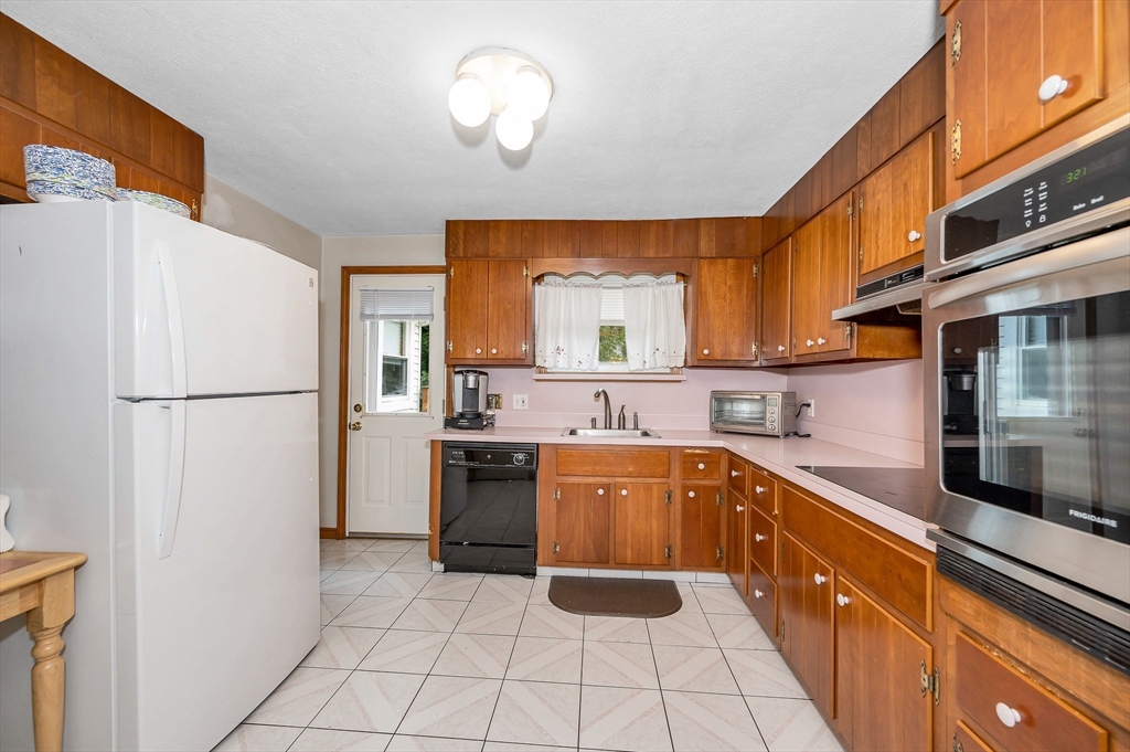 303 Walnut Street Saugus, MA 01906 - Photo 11 of 41 a kitchen with a sink a refrigerator and cabinets