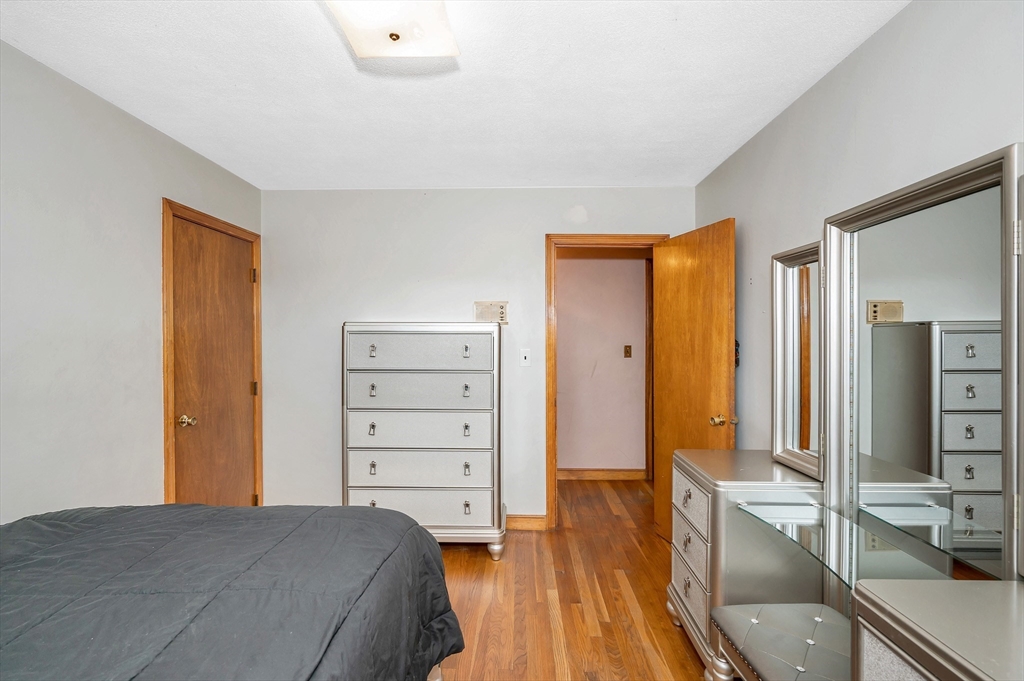 303 Walnut Street Saugus, MA 01906 - Photo 17 of 41 a bedroom with a bed and wooden floor