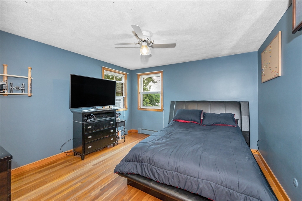 303 Walnut Street Saugus, MA 01906 - Photo 18 of 41 a bedroom with a bed and a flat screen tv