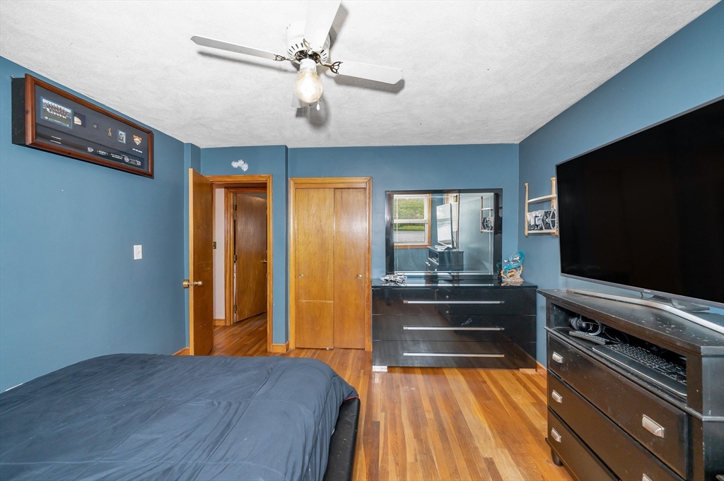 303 Walnut Street Saugus, MA 01906 - Photo 20 of 41 a bedroom with a bed and a flat screen tv