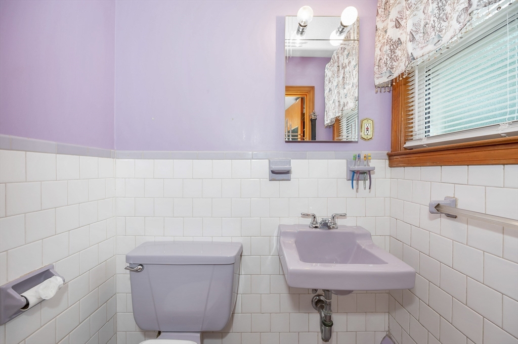 303 Walnut Street Saugus, MA 01906 - Photo 23 of 41 a bathroom with a sink a toilet and a mirror