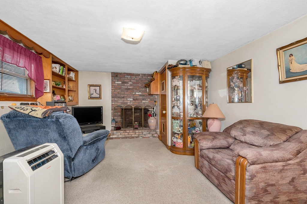 303 Walnut Street Saugus, MA 01906 - Photo 24 of 41 a living room with furniture and a fireplace