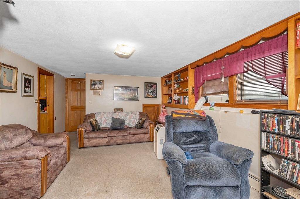 303 Walnut Street Saugus, MA 01906 - Photo 25 of 41 a living room with furniture and a flat screen tv