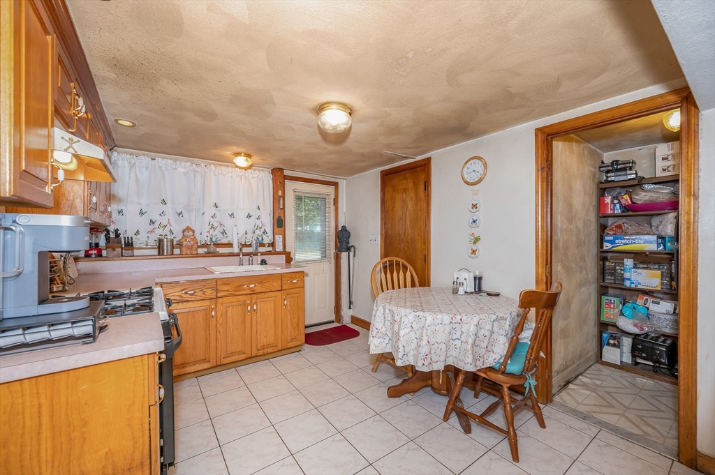 303 Walnut Street Saugus, MA 01906 - Photo 26 of 41 a living room with furniture and a dining table with rug