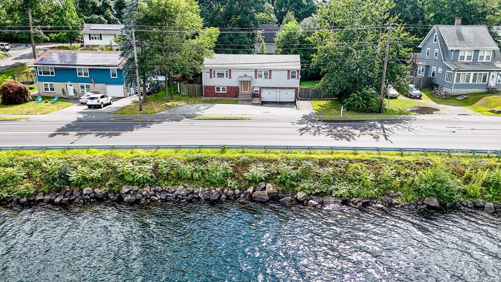 303 Walnut Street Saugus, MA 01906 - Photo 37 of 41 a view of a house with a yard and sitting area