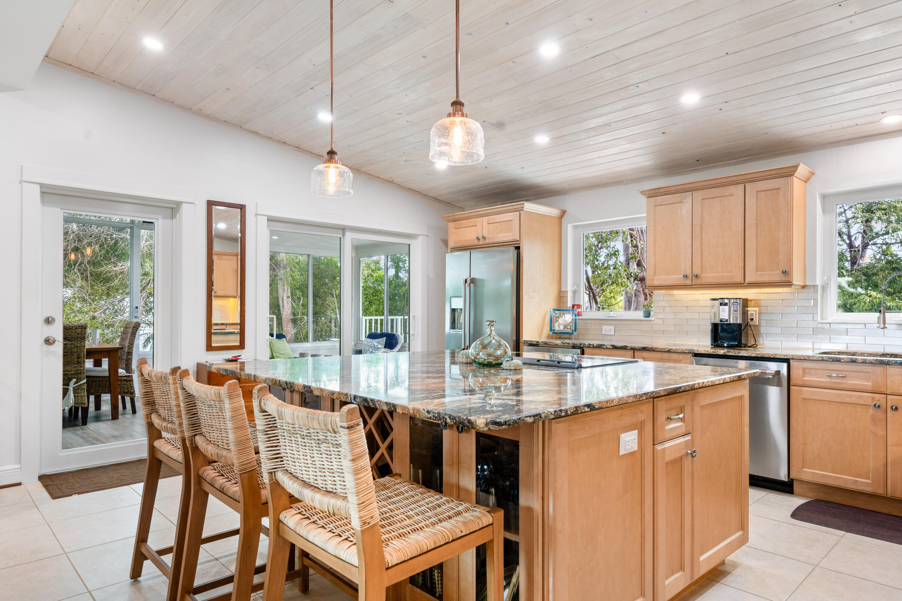 a dining hall with stainless steel appliances granite countertop a stove and a sink