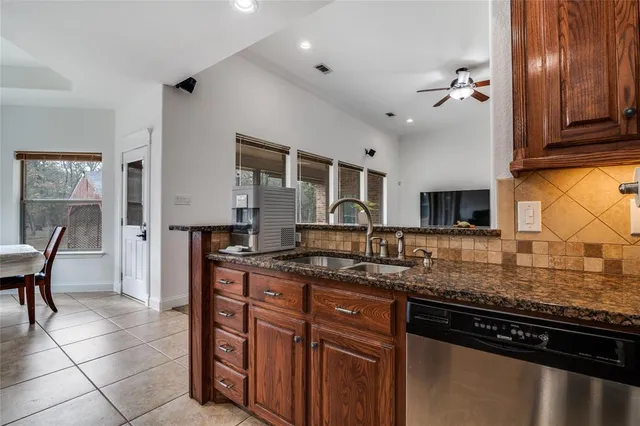a kitchen with stainless steel appliances granite countertop a sink and cabinets