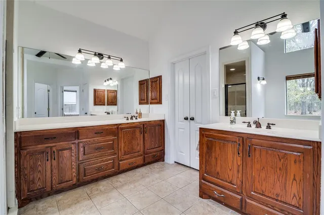 a spacious bathroom with a double vanity sink double and mirror