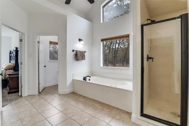 a spacious bathroom with a bathtub and a shower