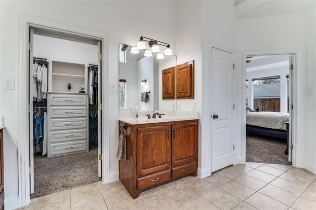 a bathroom with a sink vanity and mirror