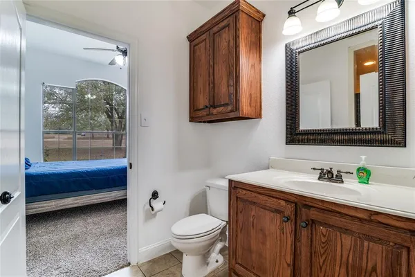 a bathroom with a toilet a sink and mirror