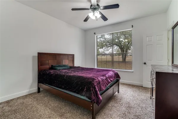 a bedroom with a bed and window