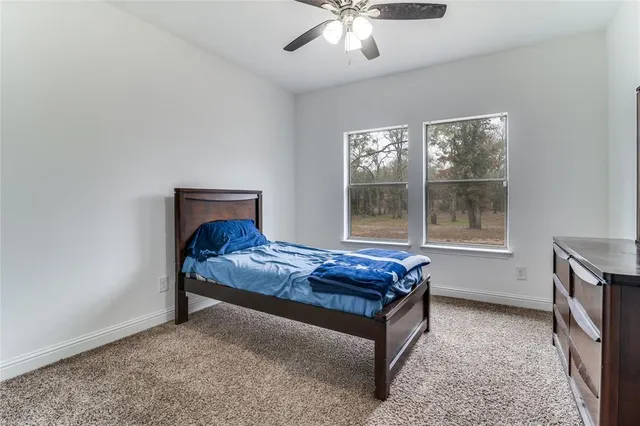 a bed sitting in a room next to a window