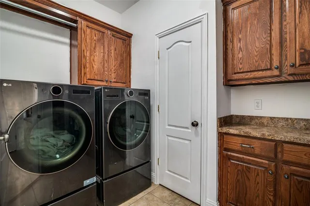 a utility room with sink dryer and washer
