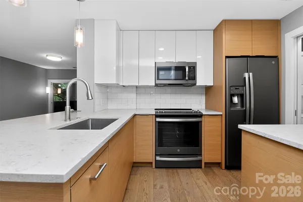 a kitchen with stainless steel appliances a stove microwave and refrigerator