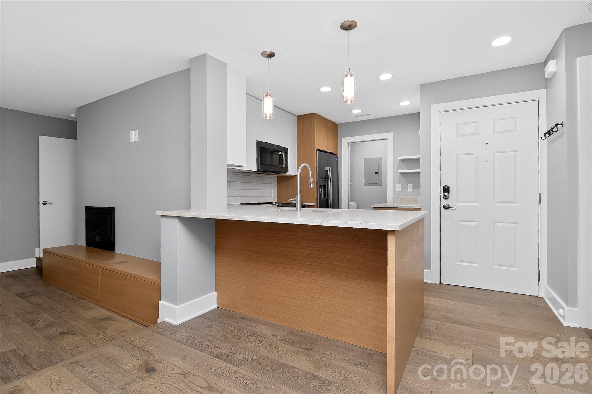 603 Queens Road, Unit B Charlotte, NC 28207 - Photo 11 of 33 a large kitchen with stainless steel appliances kitchen island granite countertop a refrigerator and a sink