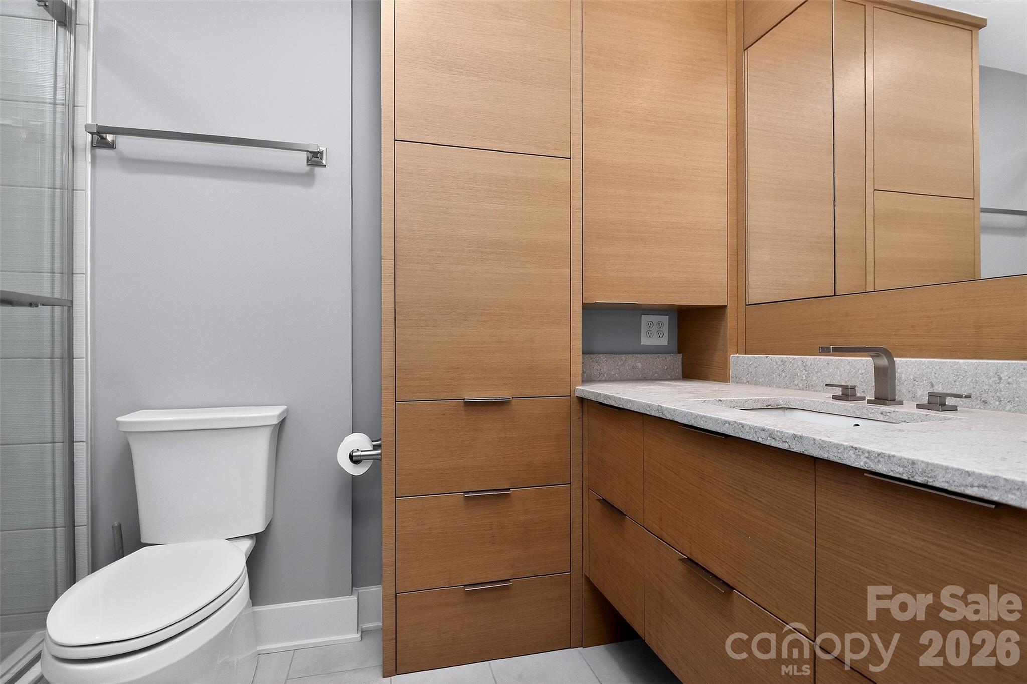 603 Queens Road, Unit B Charlotte, NC 28207 - Photo 21 of 33 a bathroom with a granite countertop sink toilet and shower