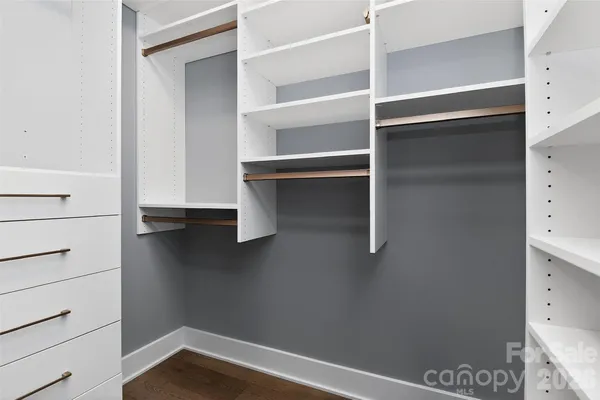 a view of walk in closet with empty racks